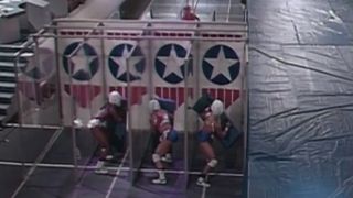 Gladiators standing behind the paper doors in the Eliminator round in American Gladiators S2 E2.