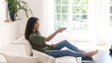 Smiling woman watching TV