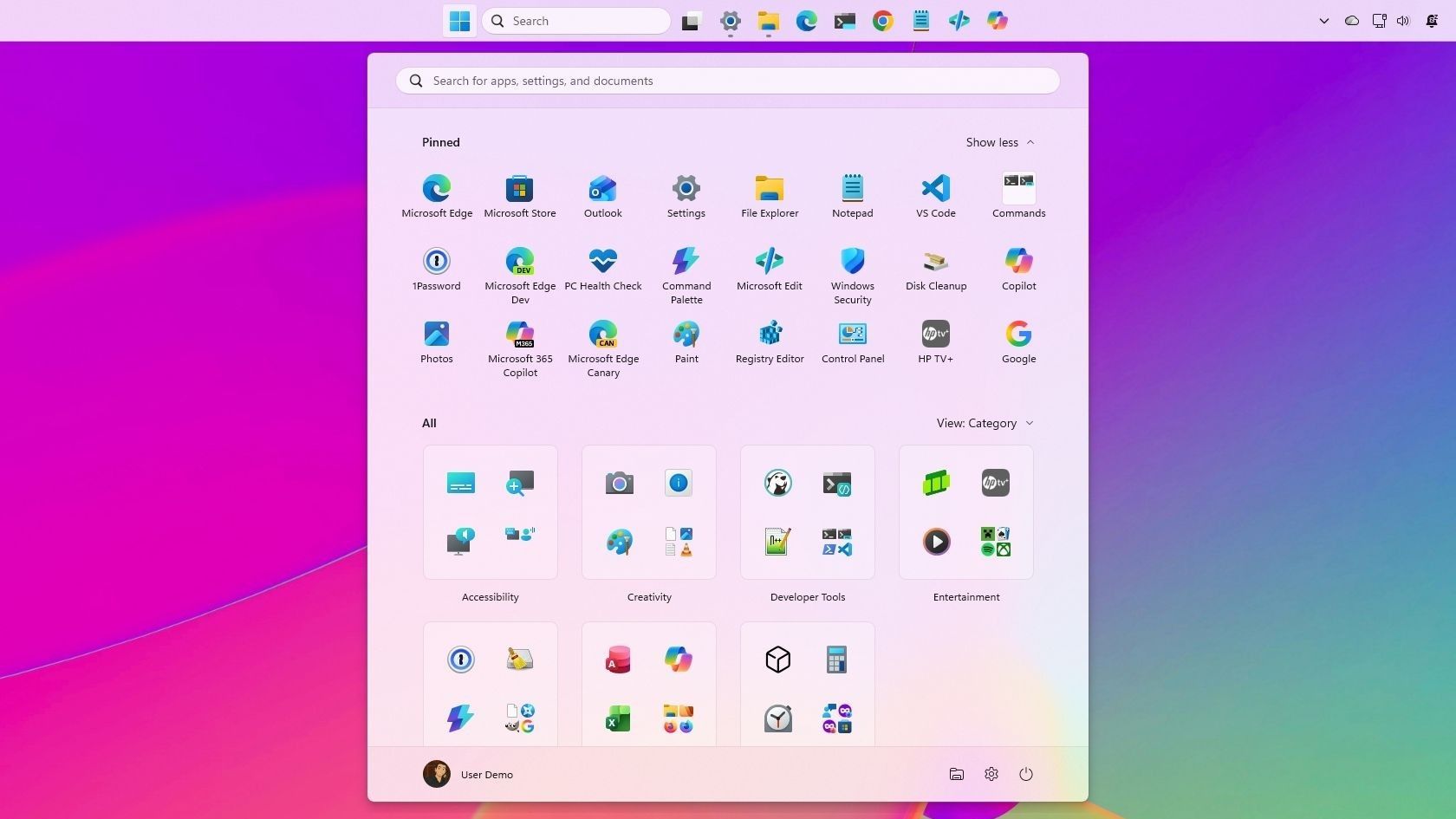 A Windows 11 desktop showing the taskbar aligned to the top of the screen with centered app icons and a search bar. The Start menu is open below the top taskbar, displaying pinned apps and category folders over a colorful pink, purple, and green gradient background.