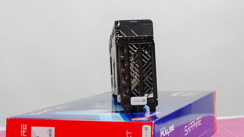 An AMD Radeon RX 9070 XT made by Sapphire on a table with its retail packaging