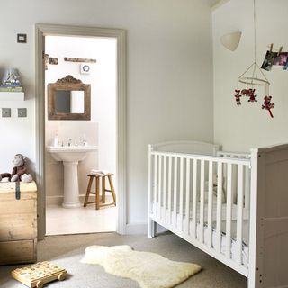 kids room with white walls and white cabinet bed