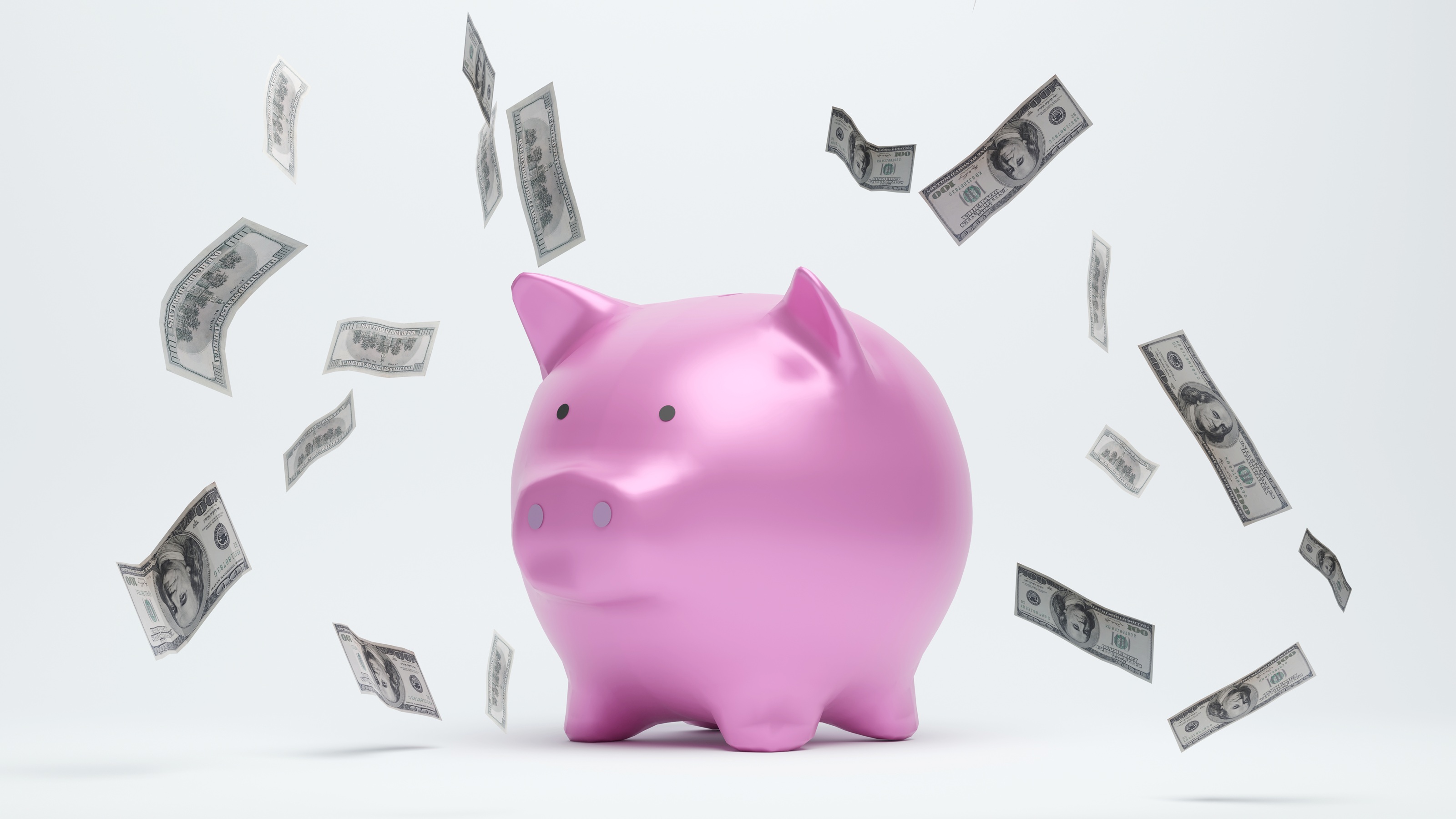 Cash floats around a piggy bank.