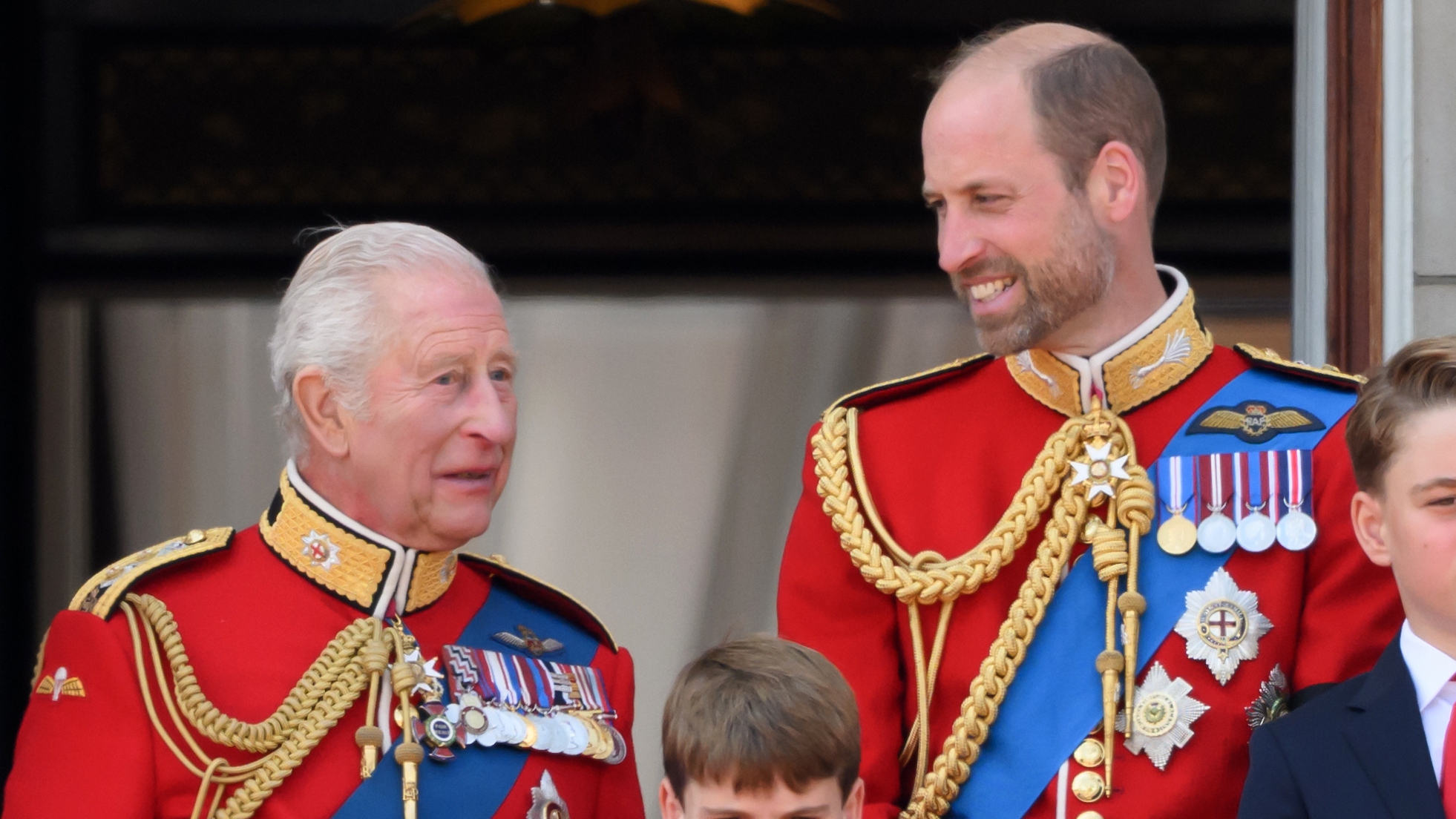 King Charles and Prince William look at each other on the balcony at Buckingham Palace during Trooping The Colour 2025 on June 14, 2025