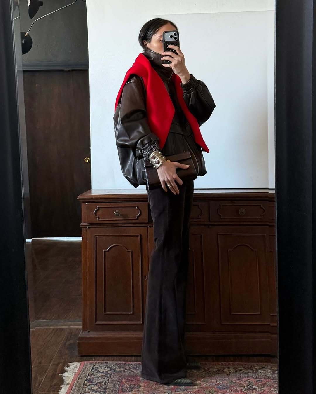 Brown jacket, red jumper and brown trousers outfit.