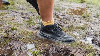 Hiker's feet wearing the Columbia Konos TRS outdry Mid Hiking Shoe