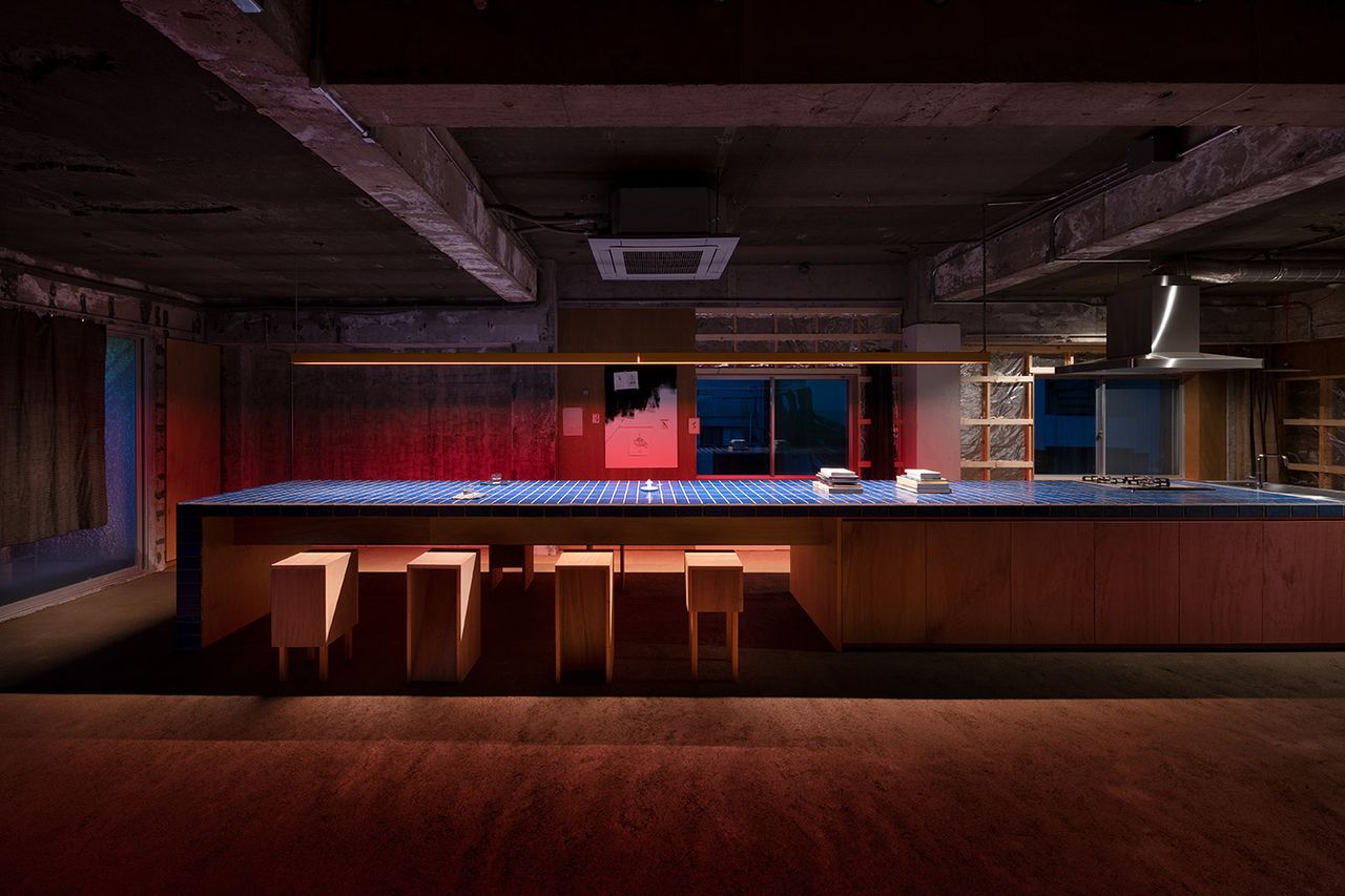 fishmarket brutalist artist&#039;s studio in kanazawa, nighttime interior view