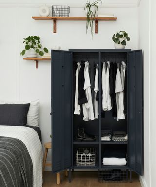 navy wardrobe with doors open showing internal hanging rails and shelves with clothes