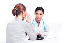 A young woman talks with her doctor