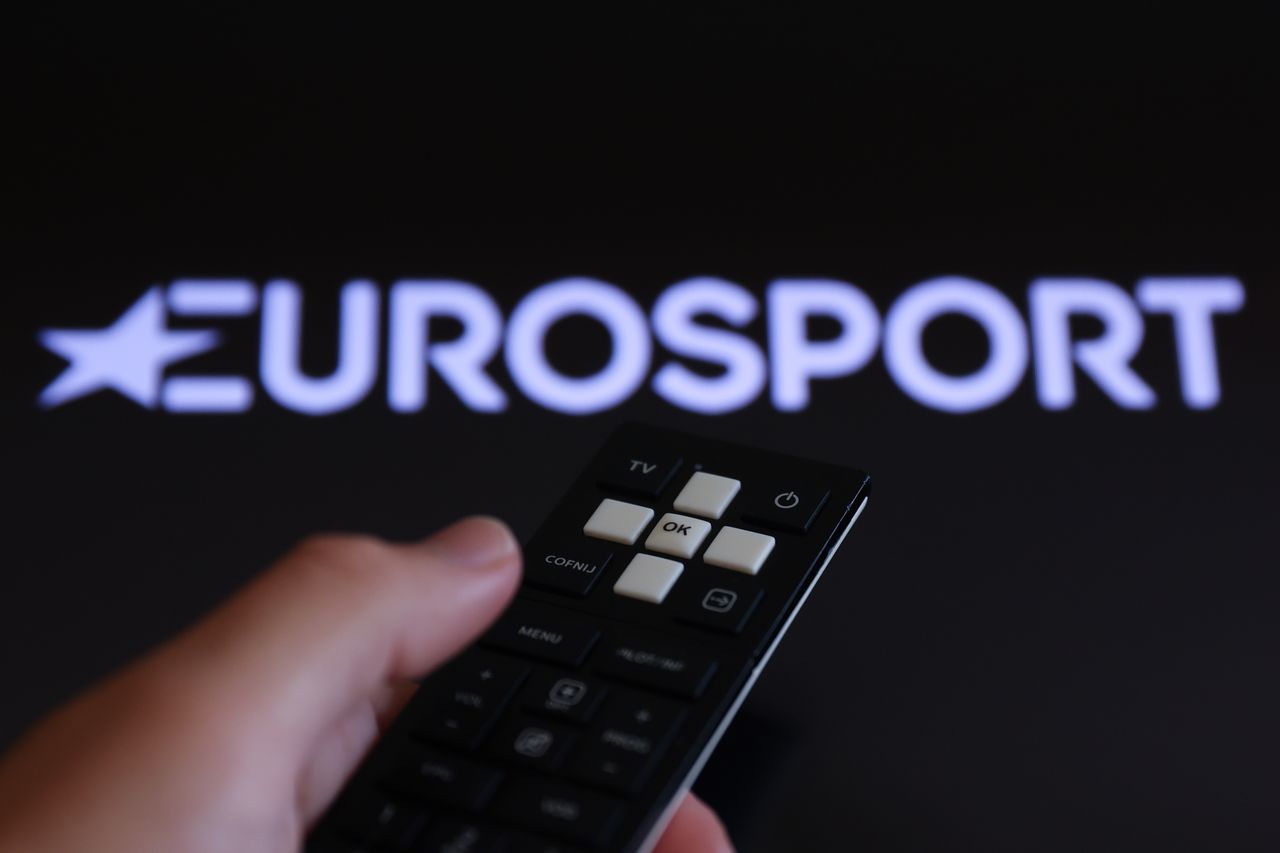 A person with a remote control watching Eurosport