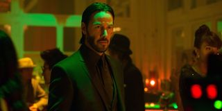 John Wick stands at a bar in a scene from the movie John Wick