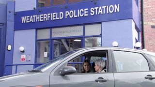 Abi and Debbie in a car outside Weatherfield Police Station.