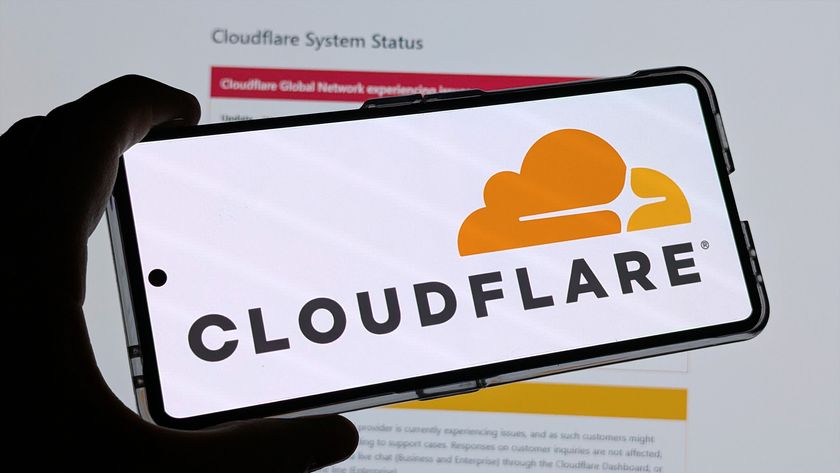 Cloudflare logo on a phone, with downtime information on a screen behind it