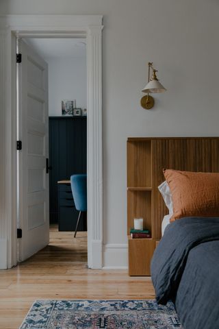 A bedroom with in-built headboard storage