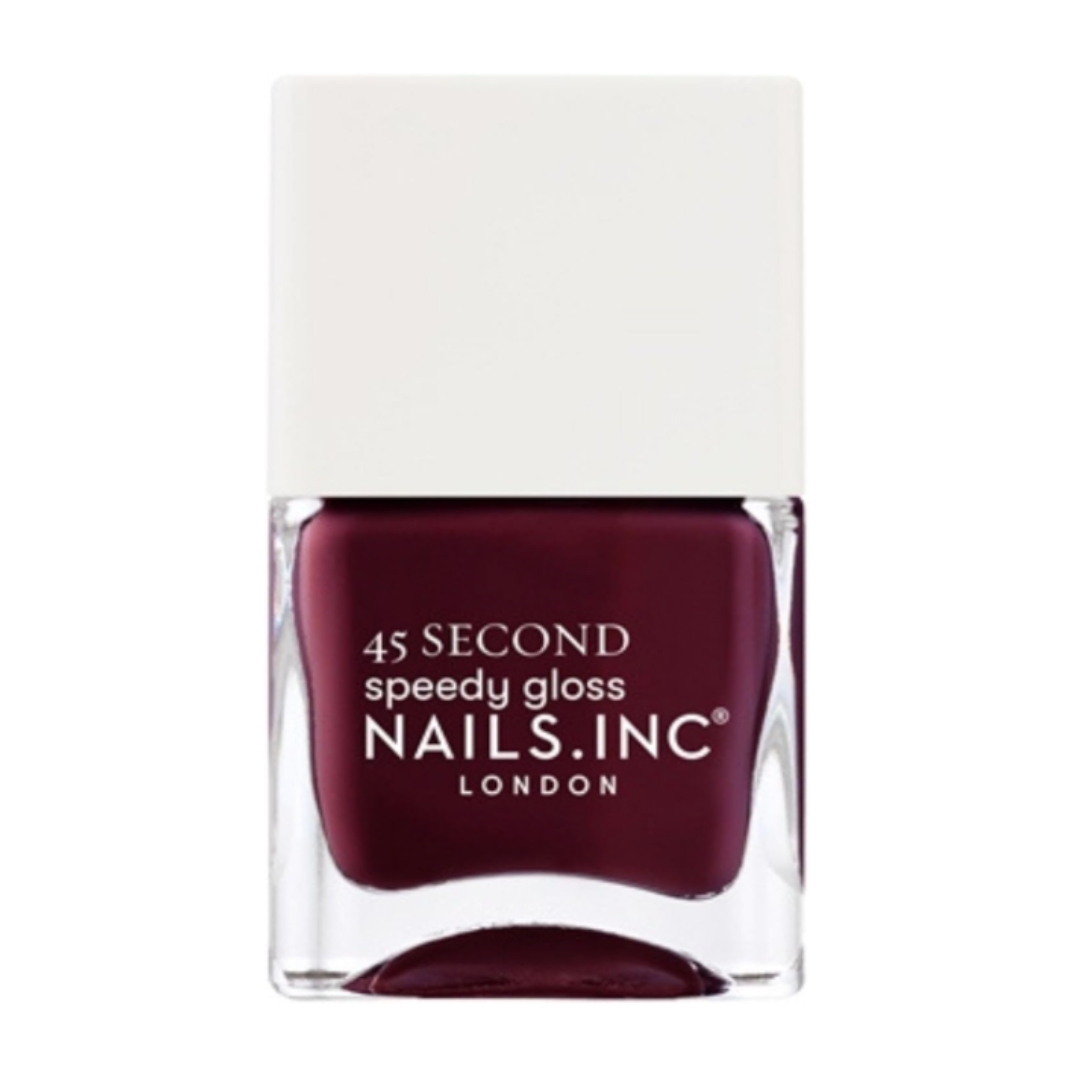 A product shot of the Nails Inc 45 Second Speedy Gloss in Shade Meet Me On Regents Street (a rich, plum colour), on a white background