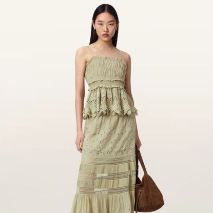 Woman wearing green Allsaints dress