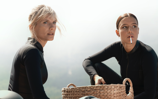 Wingwomen stars Mélanie Laurent and Adèle Exarchopoulos wearing black and looking into the distance