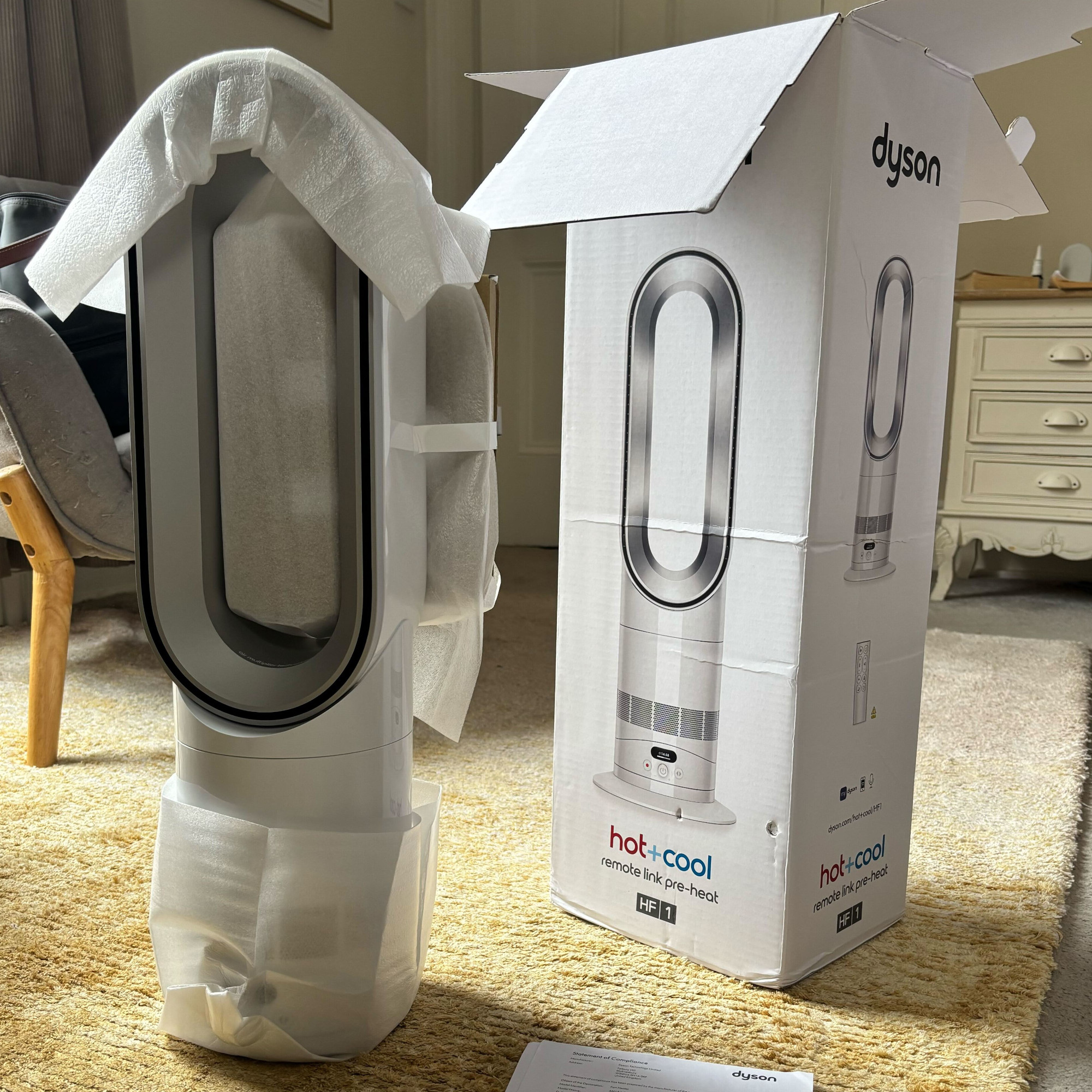 dyson hotcool pre heat heater and cooling fan out of its box in a bedroom