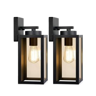 Two black rectangular wall lanterns with black rectangular bases and two warm colored hanging bulbs
