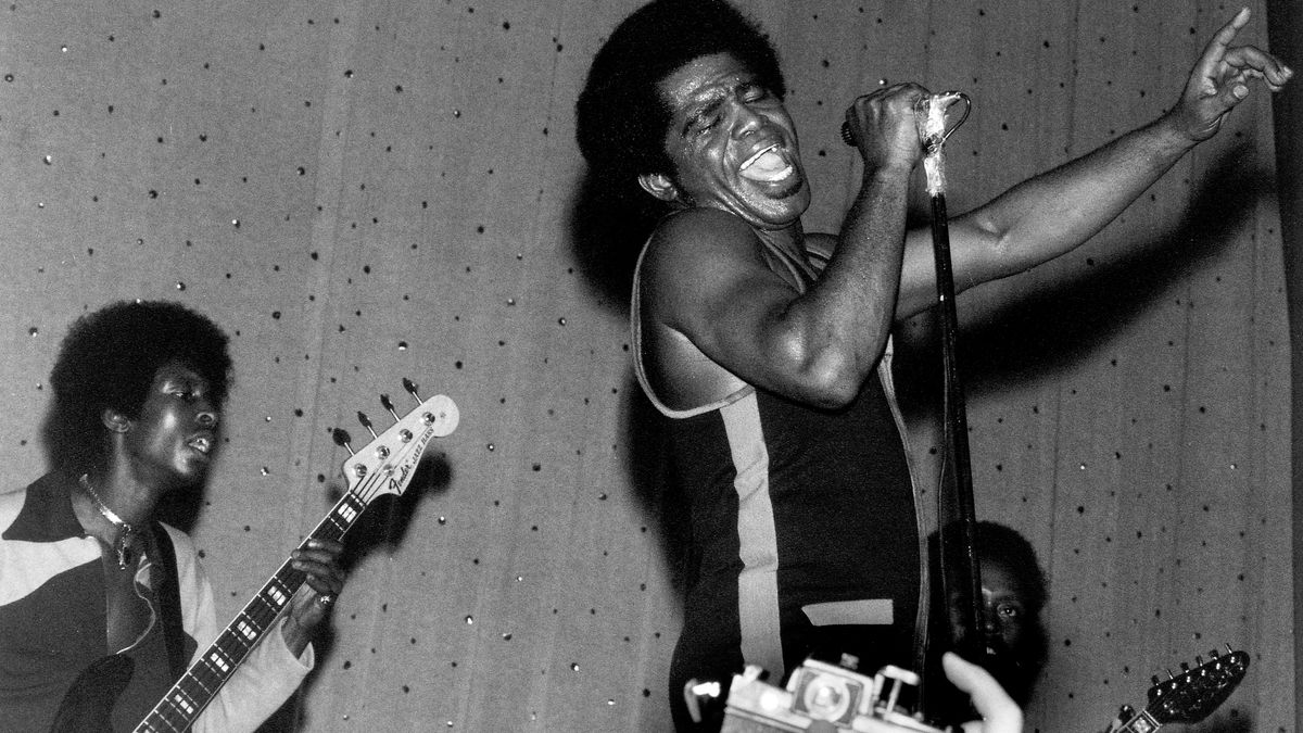 James Brown (1933-2006) performs live on stage with the J.B.&#039;s, including bass guitarist Bootsy Collins on left and guitarist Catfish Collins (1943-2010) behind on right, in East Ham, London in March 1971