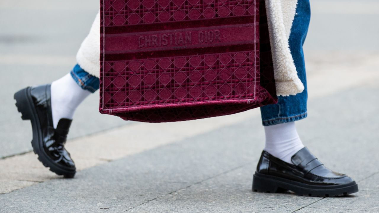 FRANKFURT AM MAIN, GERMANY - OCTOBER 26: Victoria Scheu is seen wearing creme white shearling coat Sundaybay, high waist jeans Levis, chunky loafers with white socks Zara, red Shopper tottem bag Dior on October 26, 2020 in Frankfurt am Main, Germany. (Photo by Christian Vierig/Getty Images)