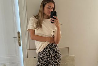 woman in leopard pants and white tee