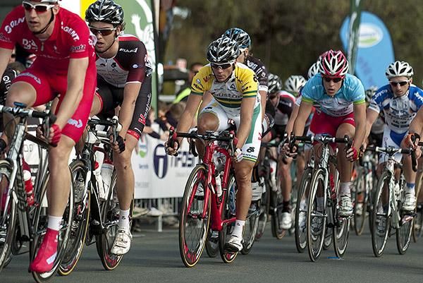 The peloton head down the home straight with a lap to go.