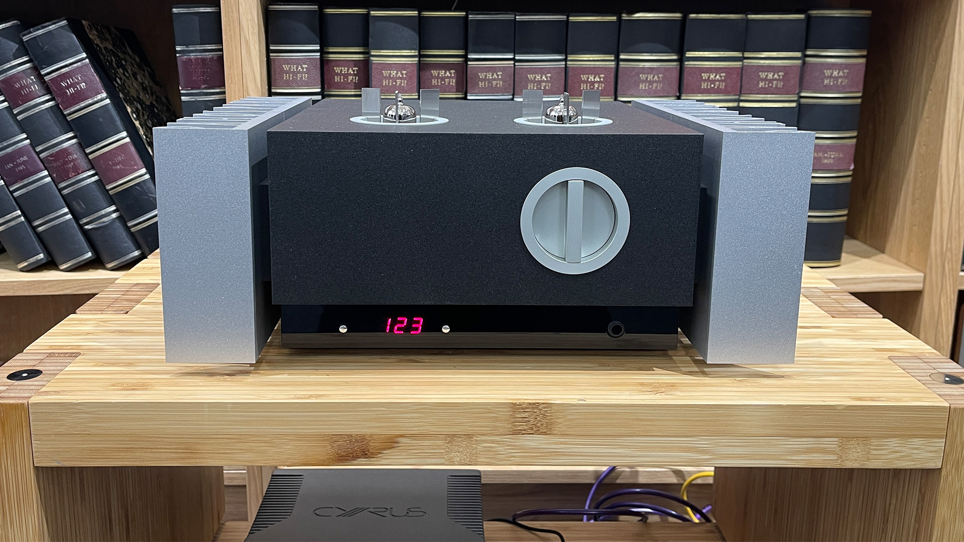 Pathos Inpol Remix MkII integrated amplifier on wooden hi-fi rack in front of bookcase