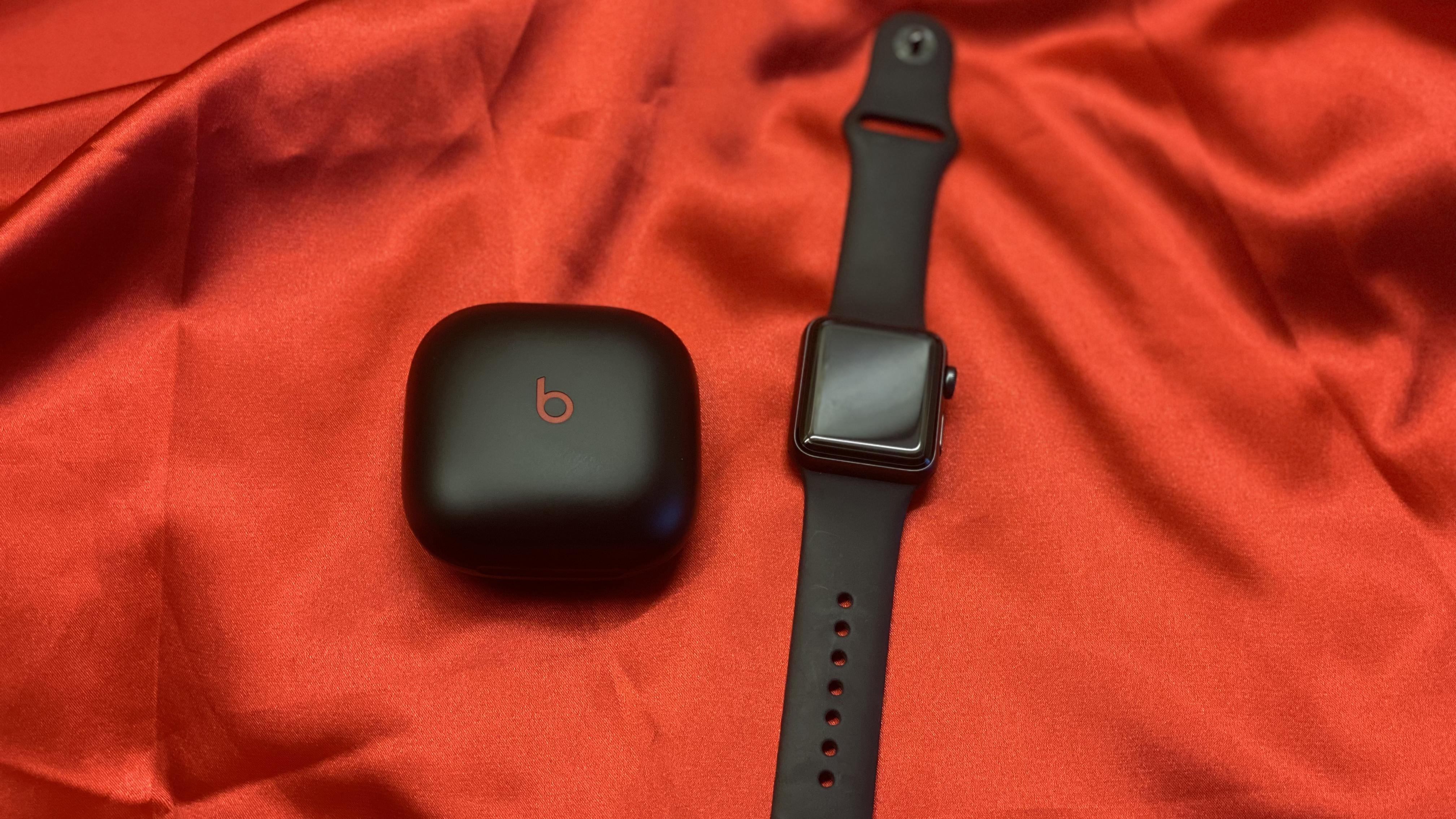 Beats Fit Pro on a red backdrop