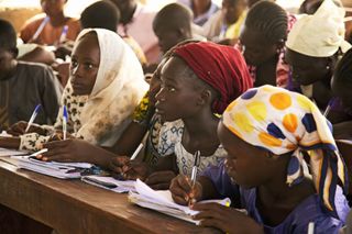 Young girls uprooted by the Boko Haram insurgency study at a temporary school in Yola