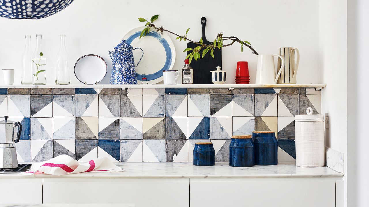 White gloss kitchen with blue and grey geo tiled splashback