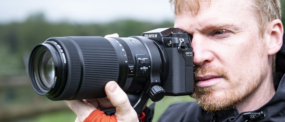 Photographer holding Fujifilm GFX100S II camera to their eye