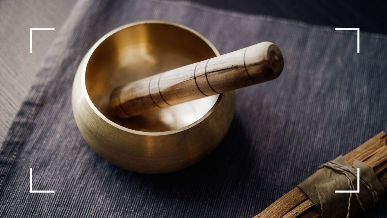 Sound bath bowl sat on placemat, representing what is a sound bath