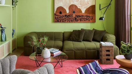 a lime green living room with a dark green sofa, a red carpeted floors and an orange artwork on the wall