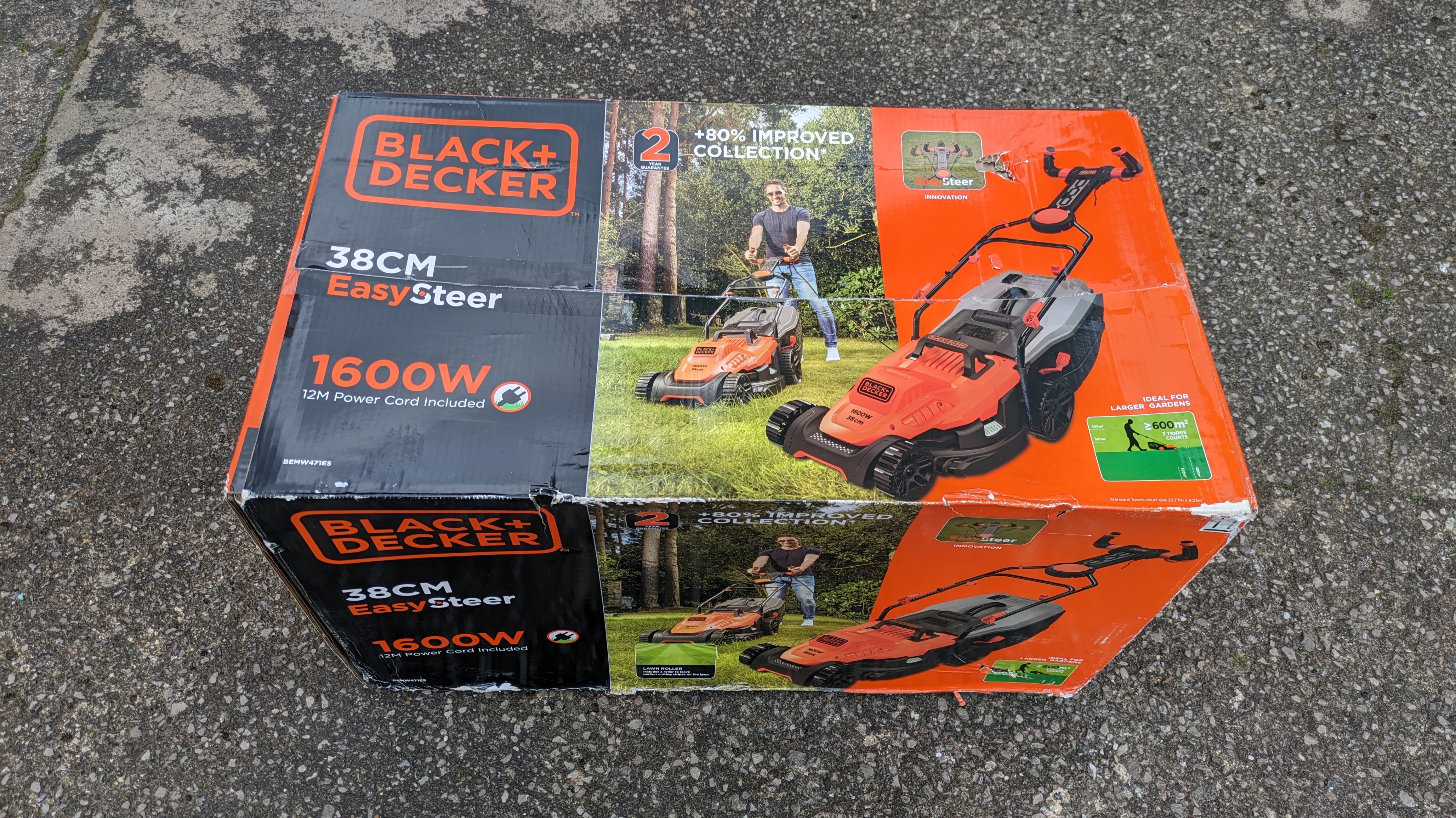 The Black + Decker lawnmower in its cardboard packaging