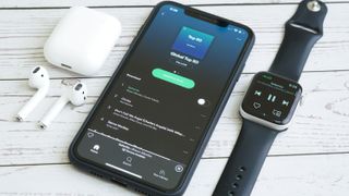 Composition of iPhone, Apple Watch and Airpods while using Spotify online music streaming apps.