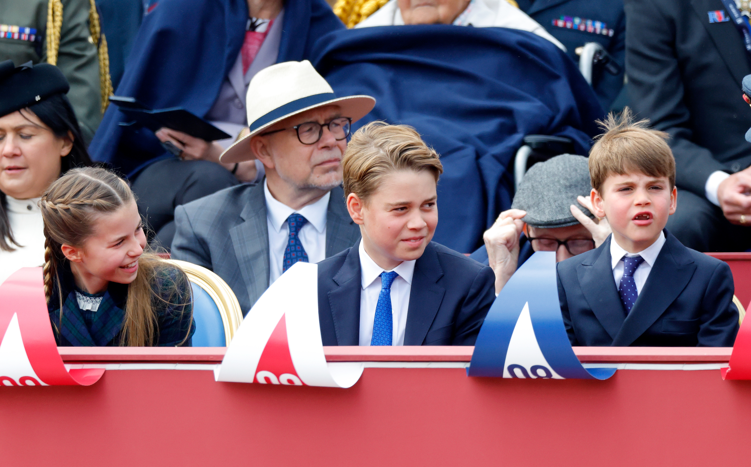 Princess Charlotte, Prince George and Prince Louis sitting in a row at the VE Day 80th anniversary parade