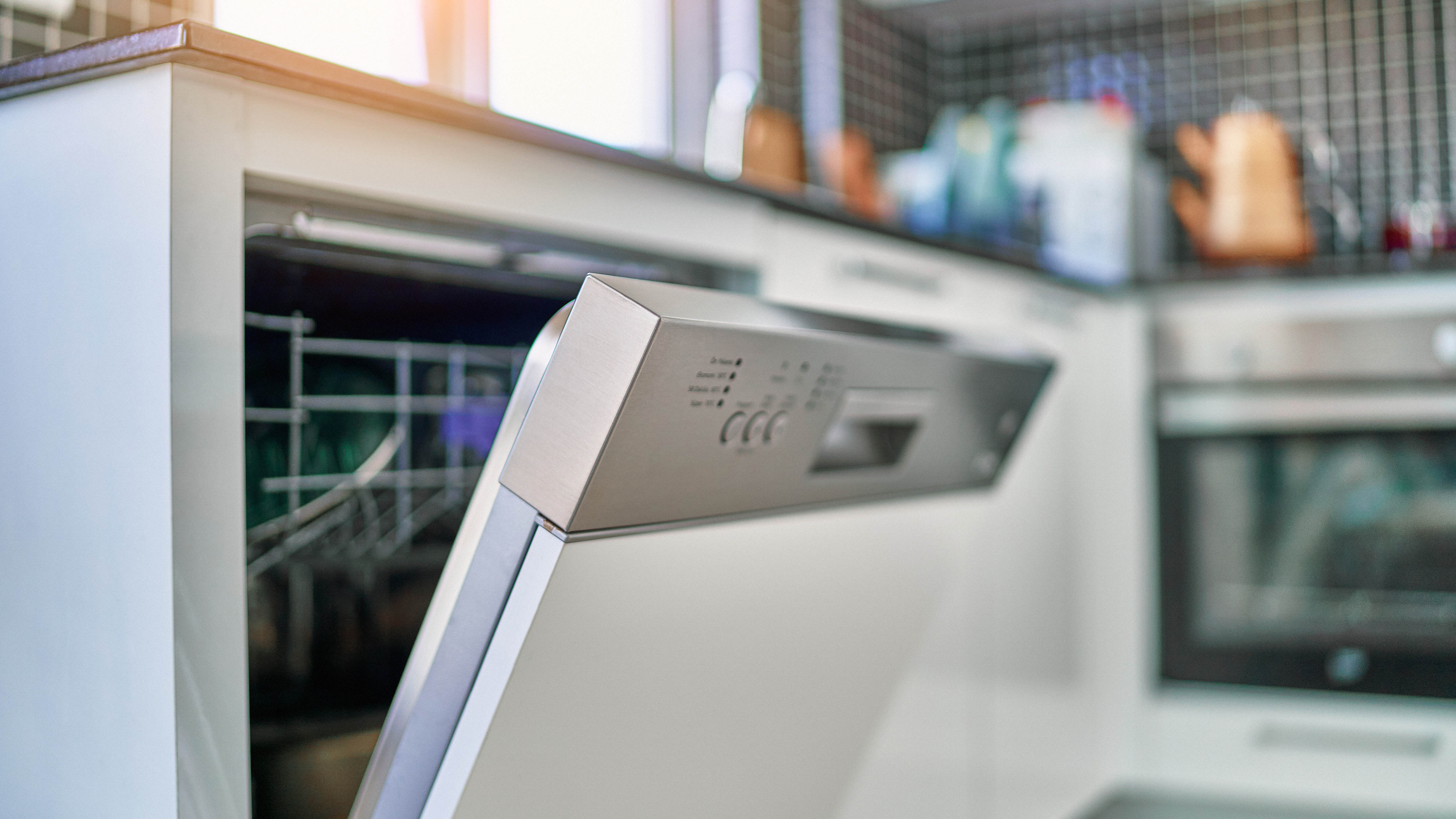 A door of a dishwasher left cracked open in a kitchen