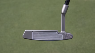 A face shot of Collin Morikawa's Logan Olson prototype putter from the side