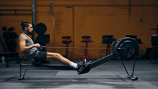 How to use the rowing machine: man performing a stroke on the rower