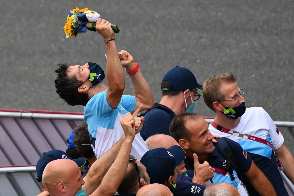 Gold medalist Slovenias Primoz Roglic celebrates with his team after the mens cycling road individual time trial during the Tokyo 2020 Olympic Games at the Fuji International Speedway in Oyama Japan on July 28 2021 Photo by Greg Baker AFP Photo by GREG BAKERAFP via Getty Images