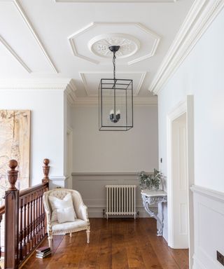 grand landing with high ceiling and wooden flooring