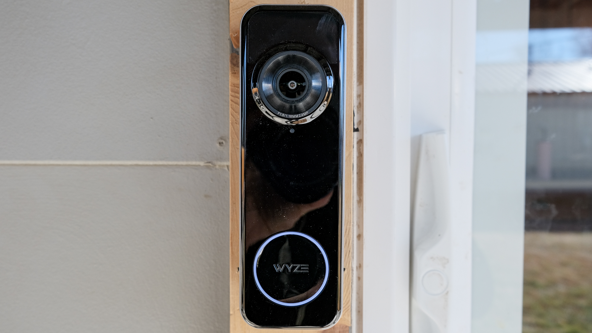 A Wyze Battery Video Doorbell mounted on a door frame