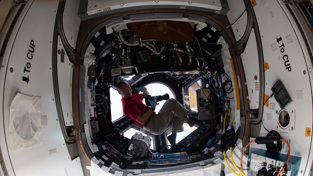 Flight Engineer Soichi Noguchi with his Nikon D5 in the ISS Cupola