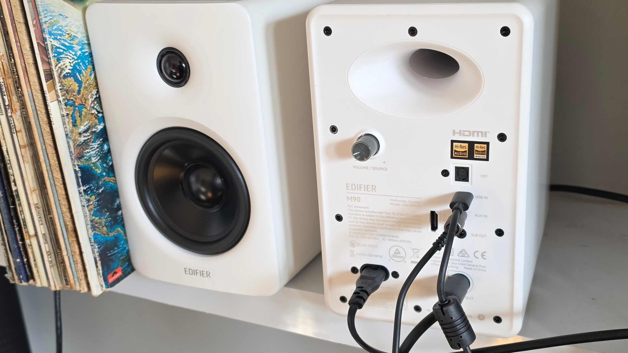 The two Edifier M90 units besides each other, with one showing its back panel.