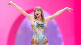 Taylor Swift onstage at Wembley Stadium on June 21st, 2024. She is wearing a sparkly gold and blue bodysuit