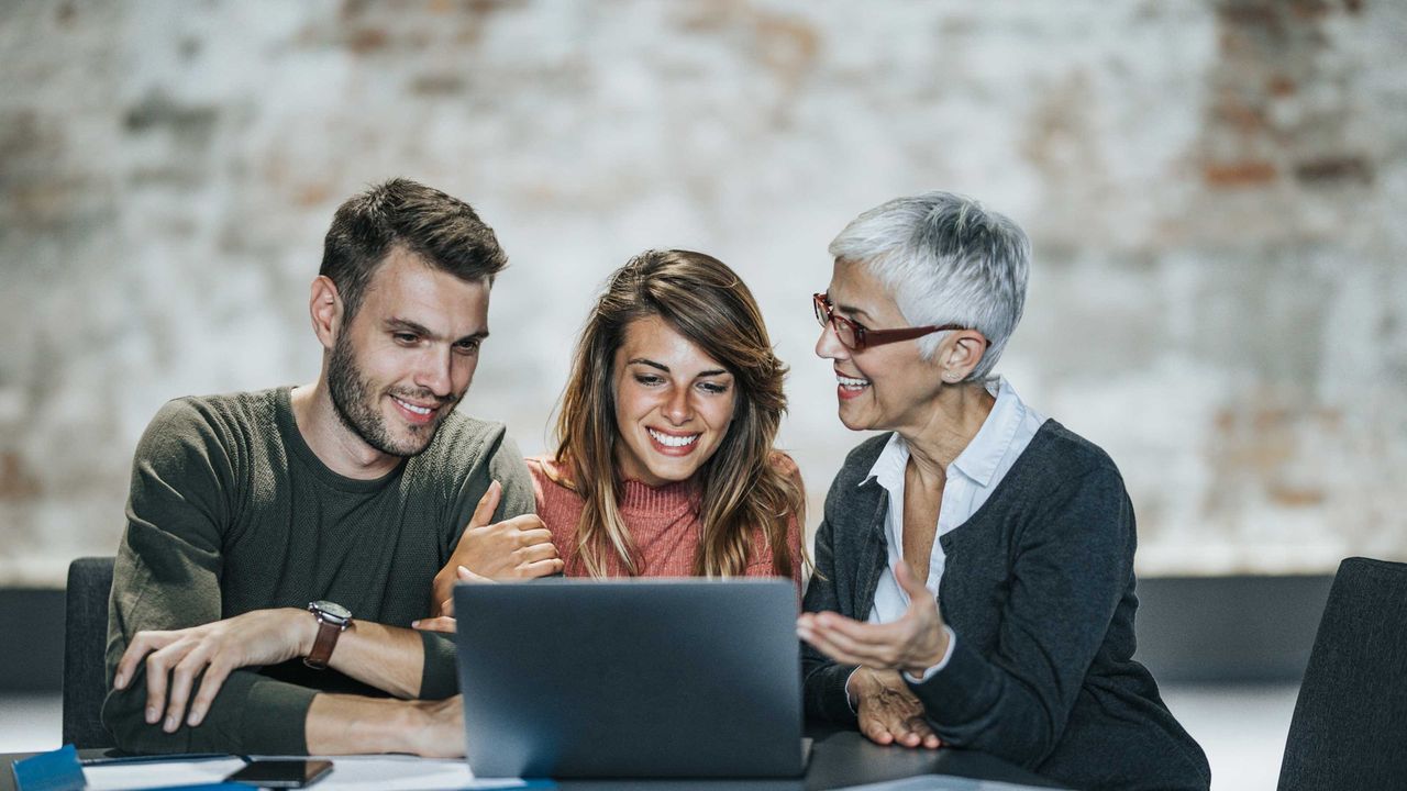 Millennial couple consulting with a senior financial adviser