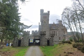 Carbisdale Castle with a gated entrance