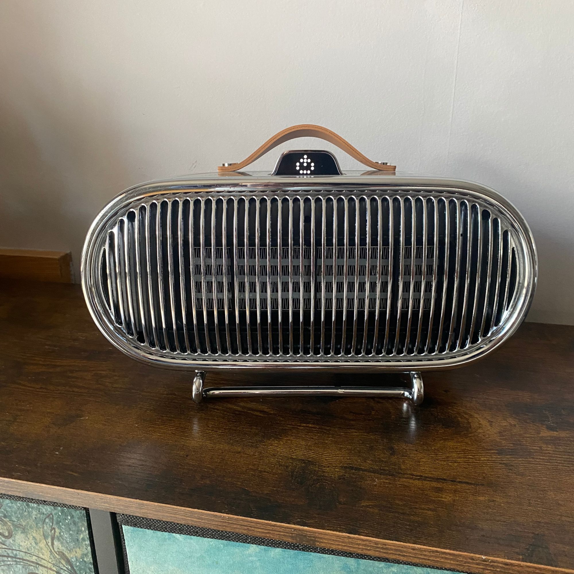 Swan 1.5kW Retro Ceramic Heater standing on a sideboard with the stand-by symbol showing on the display screen
