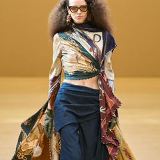 A model wearing hybrid jeans with a patterned silk cape top and sunglasses on the Zimmermann A/W 2026 runways 