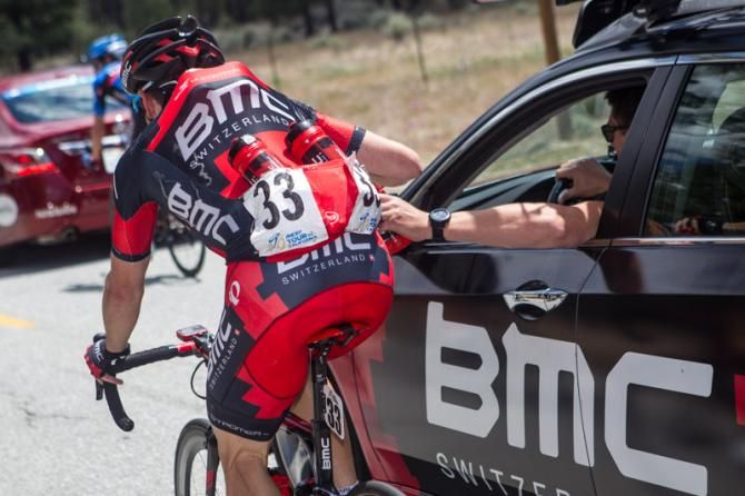 Mathias Frank (BMC) takes on some bottles from the team car